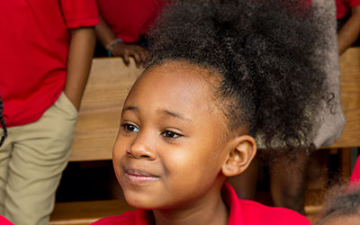 A St. Andrew's School student smiles at a subject off camera.