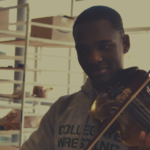 Eli Gee, a St. Andrew's School alum, playing his violin.